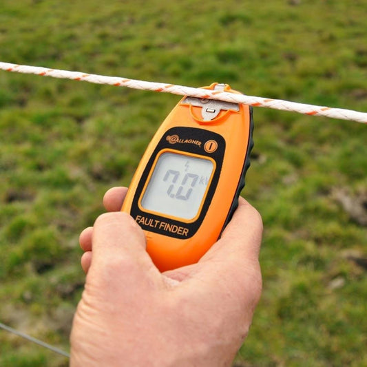 Smartfix Fault Finder / Tester from Gallagher Electric Fence at farm testing fence wire with green background